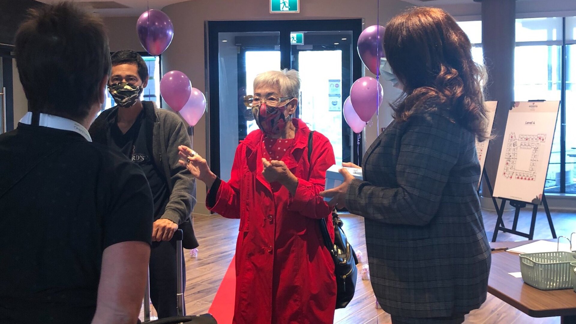 A new resident being welcomed into a senior living community