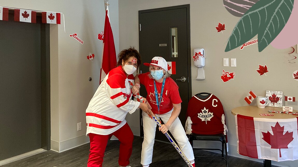 Two ladies wearing red and white on Canada Day in a senior home