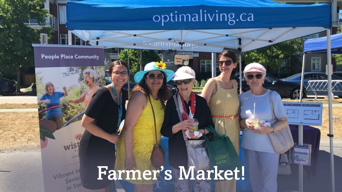 A group of women standing at optima's retirement home booth on Farmers Market event