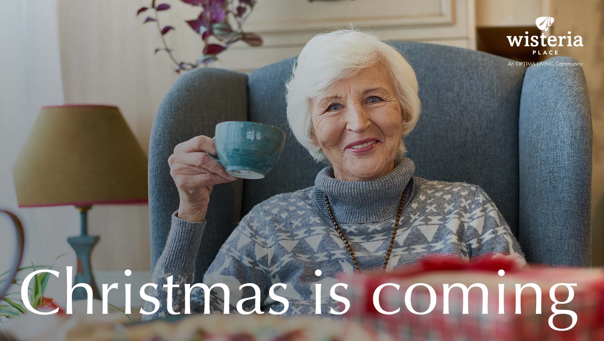 A lady drinking tea on Christmas in a senior living community