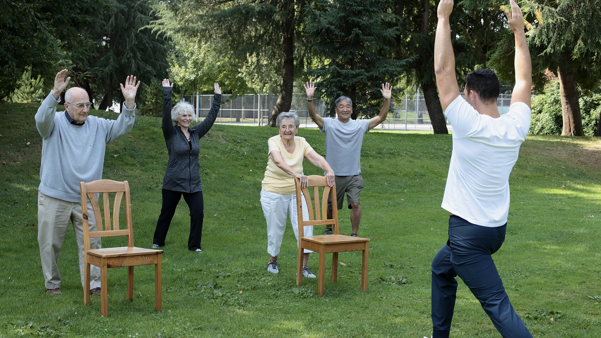 An instructor teaching people tai chi for seniors