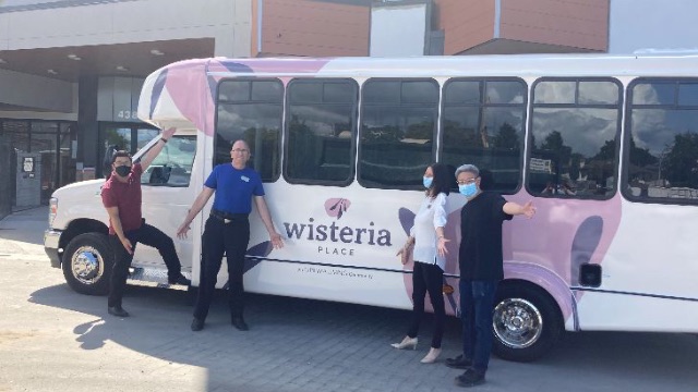 Wisteria Place senior living citizens with a shuttle bus