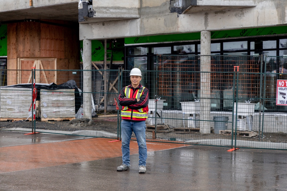 A man standing outside of construction of senior apartments