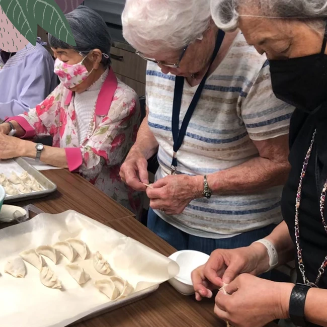 A group of senior citizens making momos