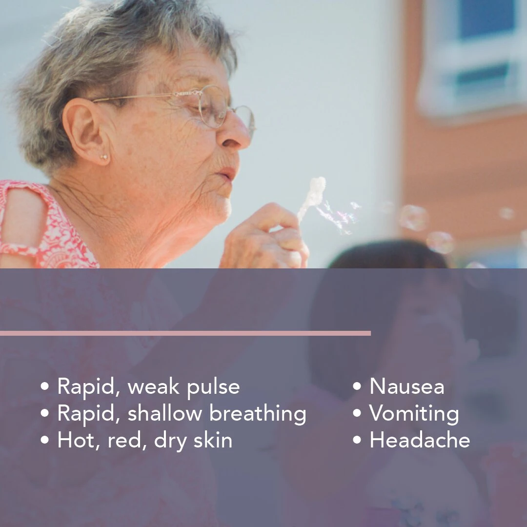 An elderly lady blowing air-bubbles with shampoo outside her senior home