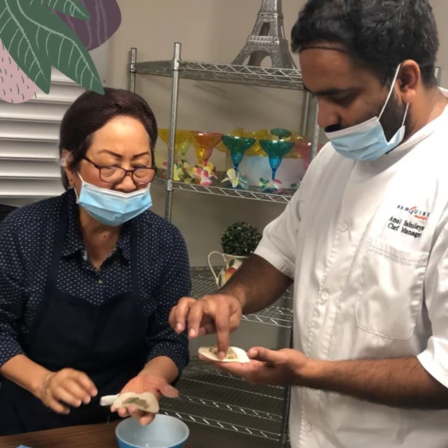Chef Amal and his assistant preparing healthy meals for seniors