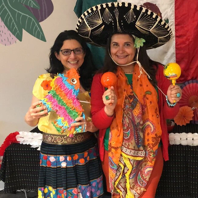 Two ladies wearing costumes in senior living