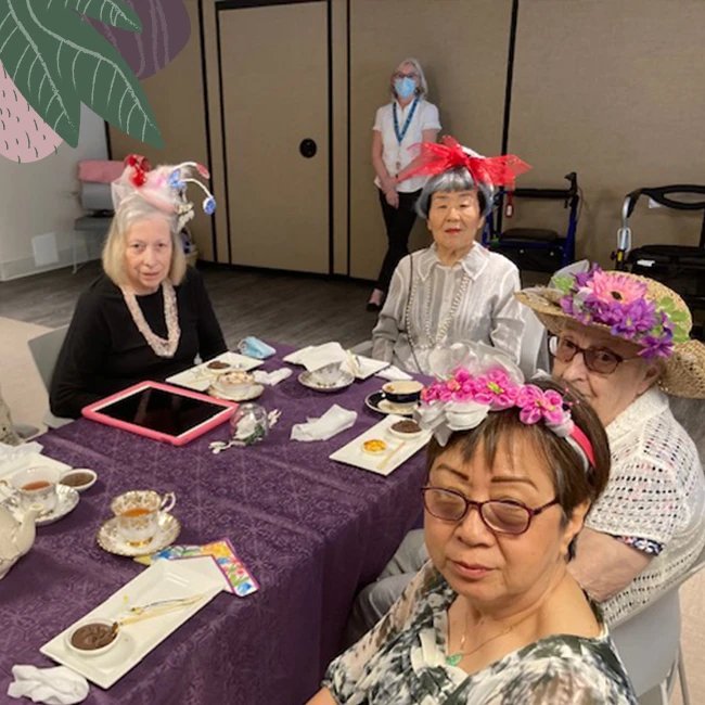 A group of senior citizens having dinner in senior living
