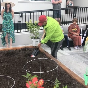 A man gardening outside his senior home