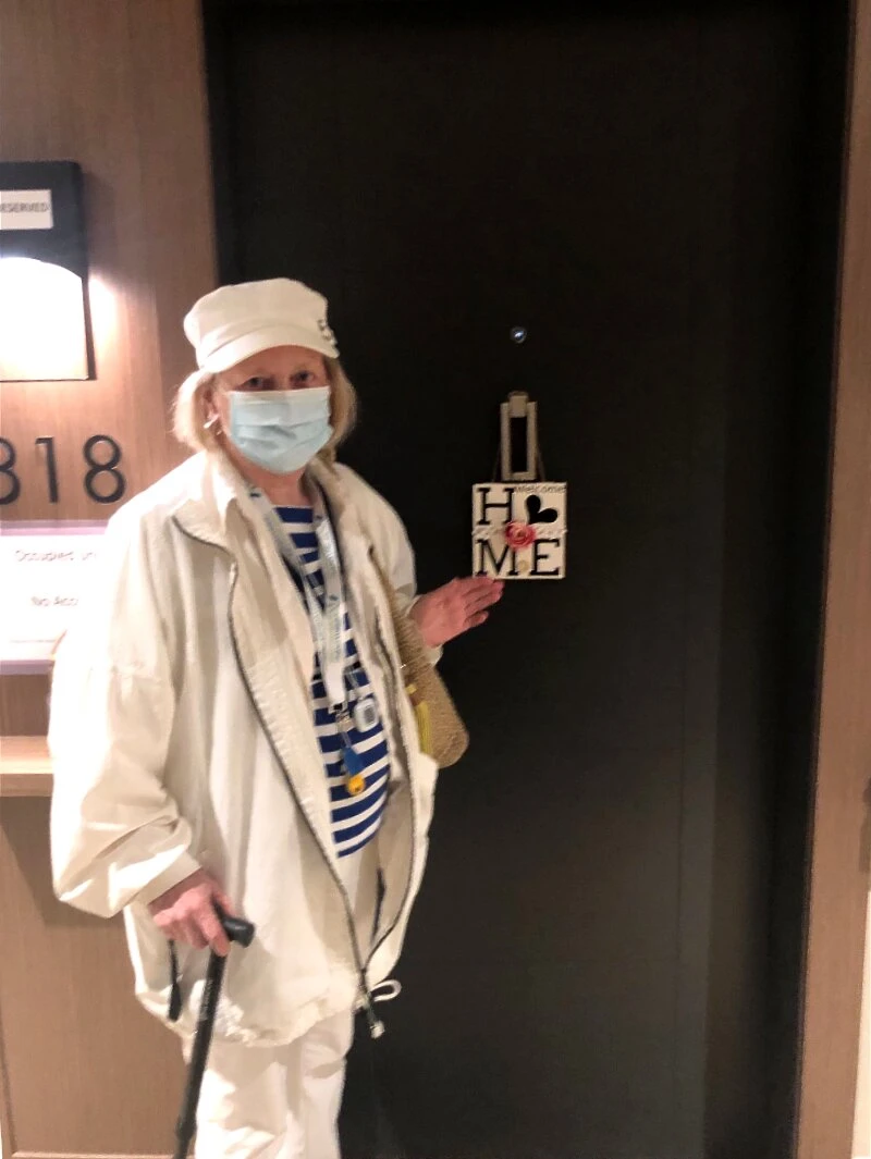 A lady standing in front of her senior apartments