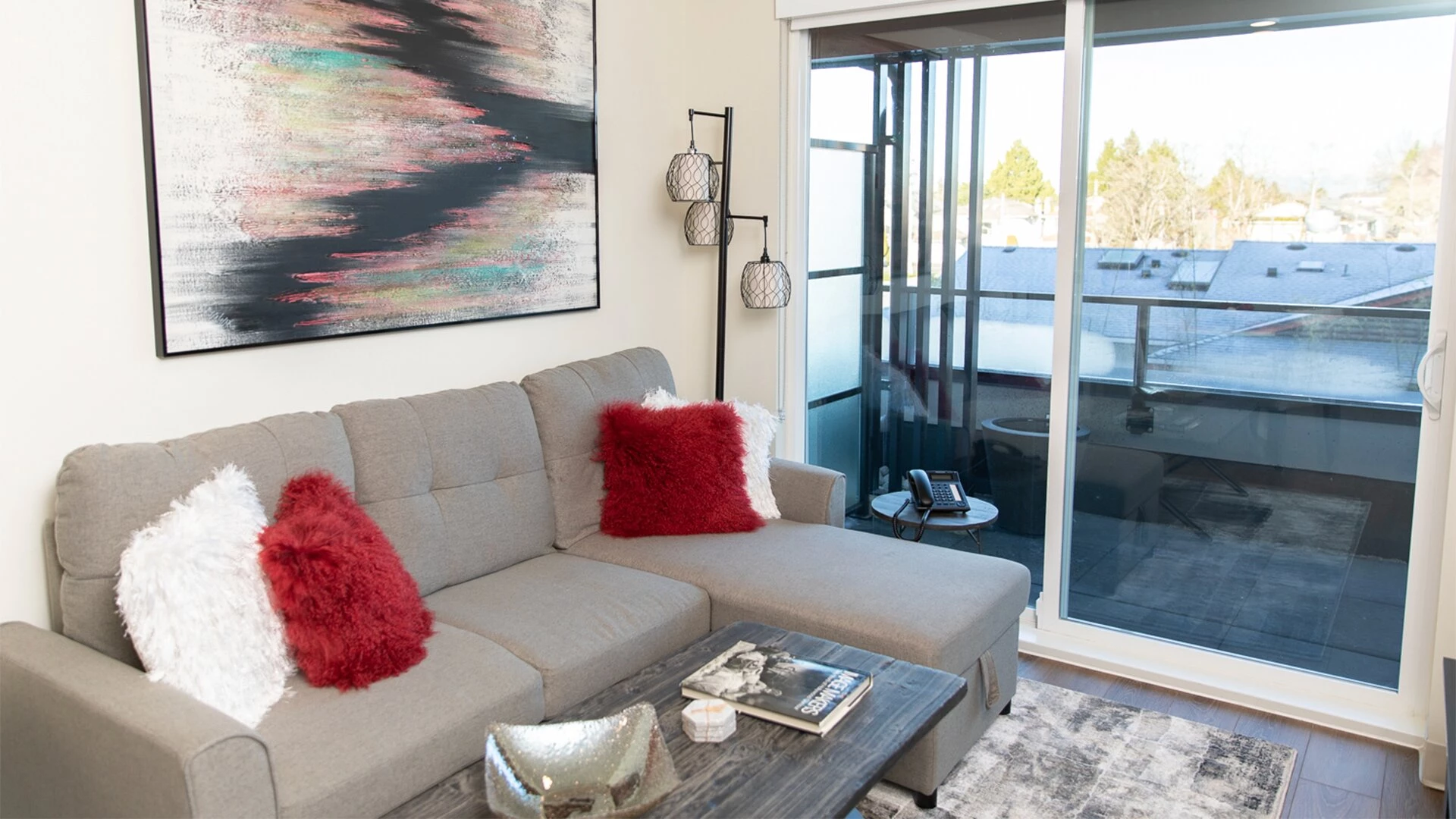 The living room and balcony of a Wisteria Place retirement home suite