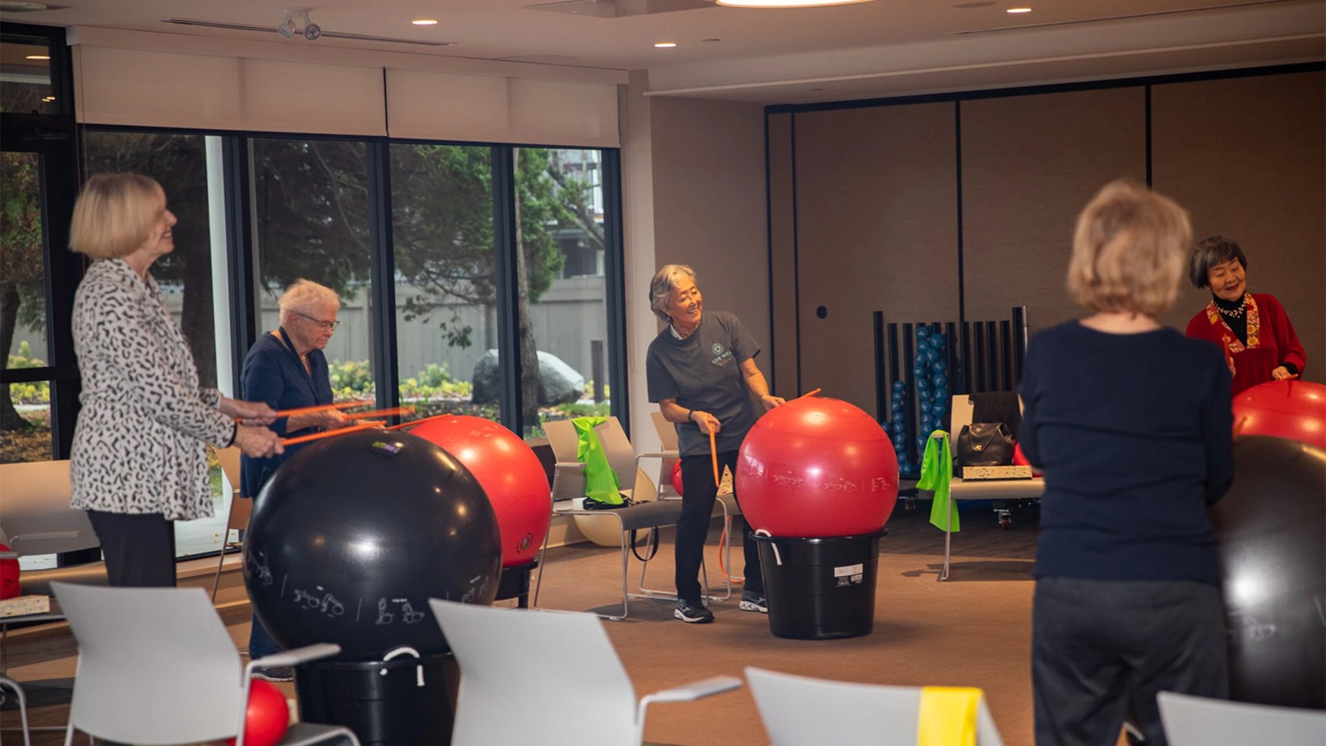 Fun activities for senior women, drumming on plastic balls