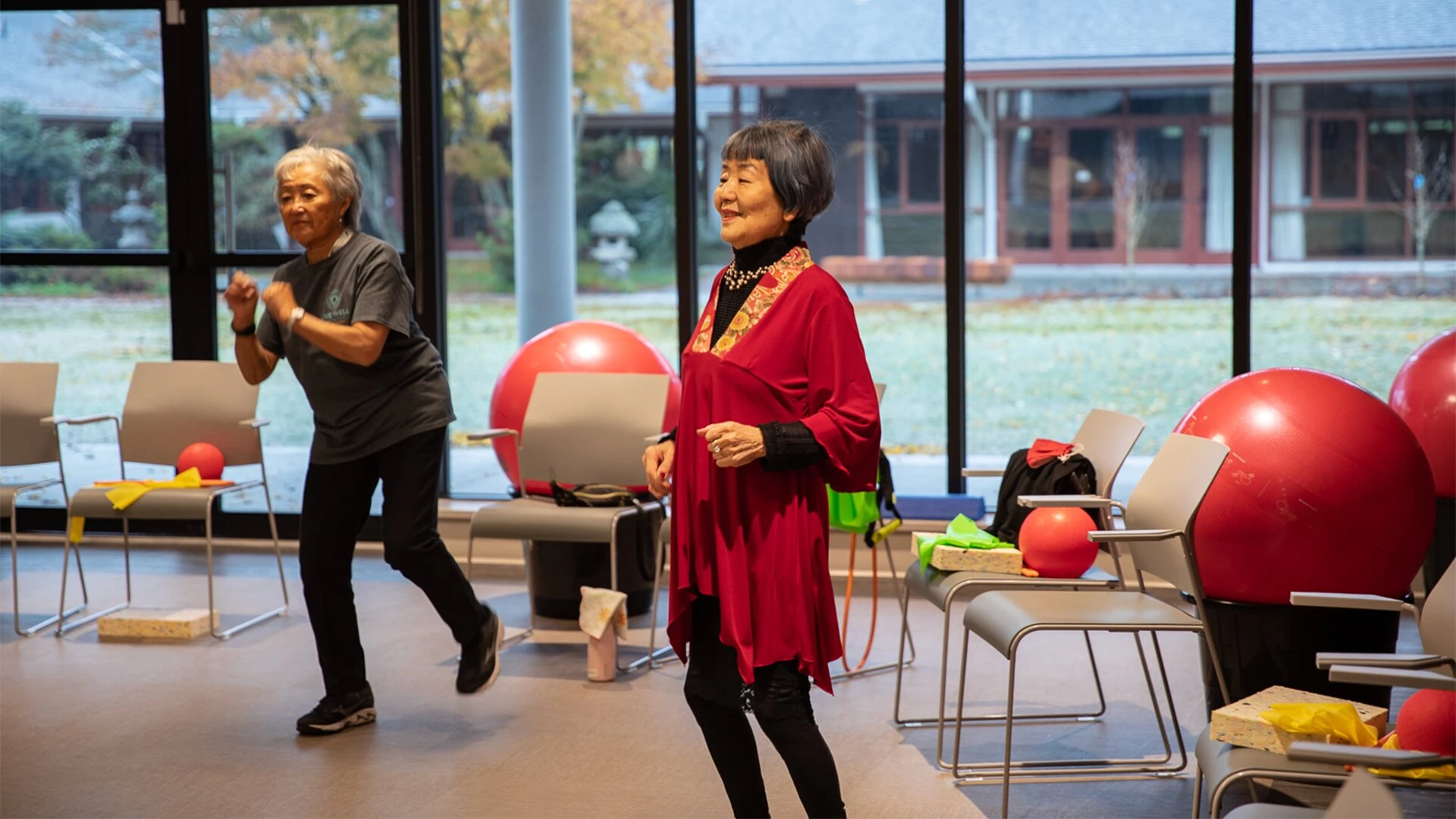 Two senior women taking an exercise for seniors over 70	class