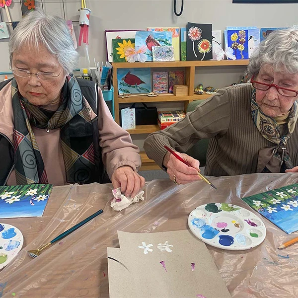 A couple of seniors painting together