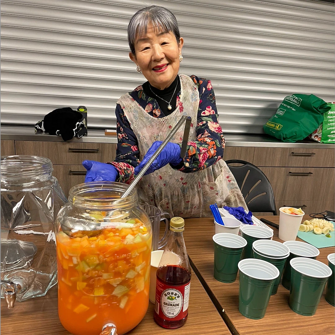 Senior serving a drink