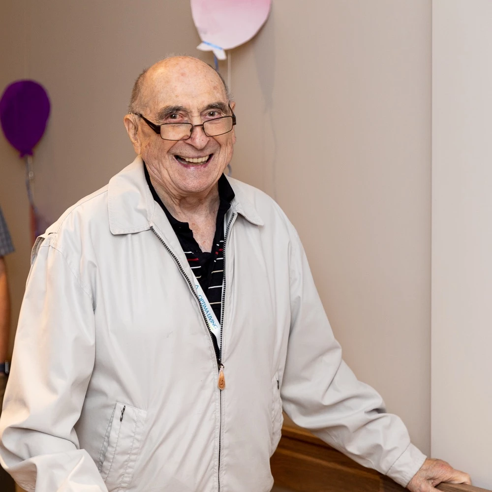 Senior man with a big smile in a light jacket in his senior living community