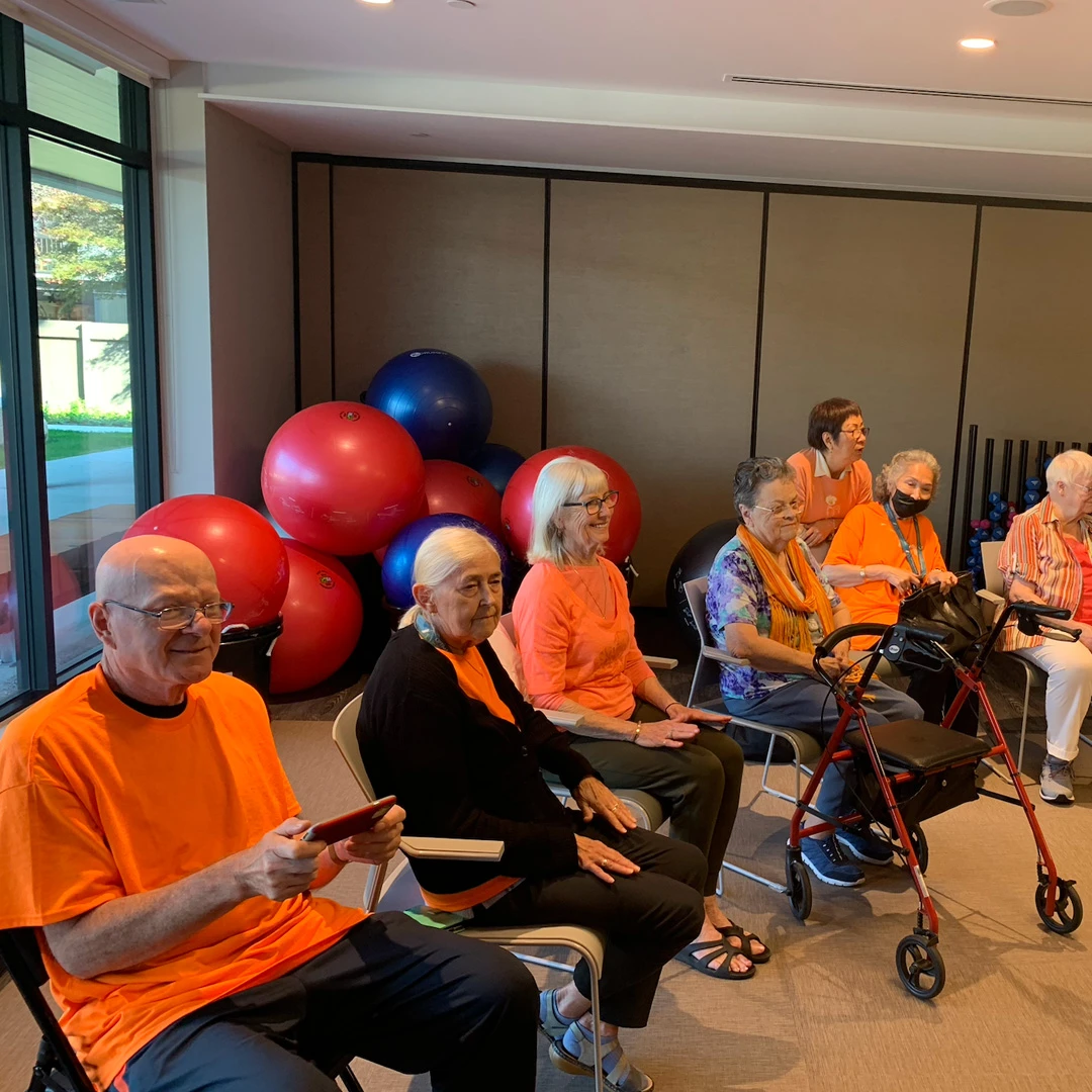 A group of senior citizens wearing orange t-shits to celebrate truth day in senior living