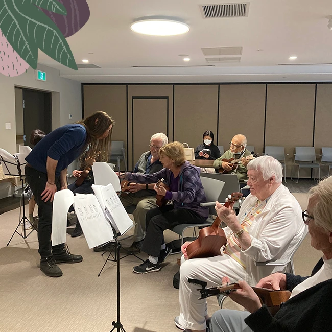 Seniors playing music on guitars in independent living for seniors
