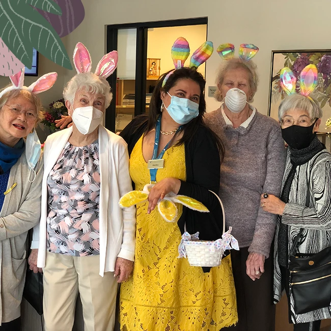Seniors and staff dressed for easter in senior apartments
