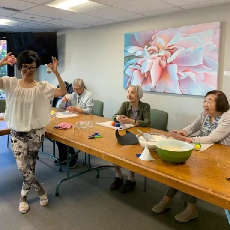 Some seniors smiling together while completing some crafts